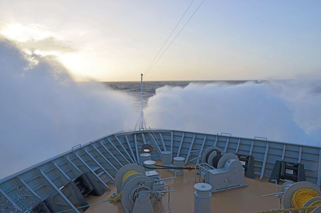 Waves breaking over the bow of an expedition ship in the Drake Passage